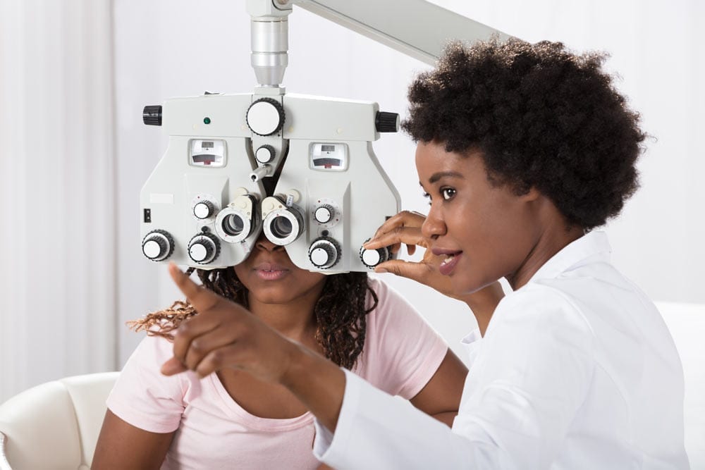 Optometrist Giving Eye Exam to Patient