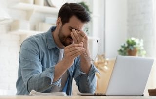 Man Experiencing Eye Pain Working From Home, Rubbing Eyes