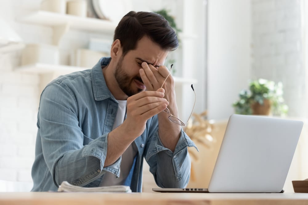 Man Experiencing Eye Pain Working From Home, Rubbing Eyes